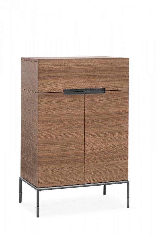 Il mobile bar Winston, design Christophe Pillet, è un esclusivo arredo ispirato ai tradizionali mobili cinesi discreti e misteriosi dall’esterno ma pieni di sorprese, dettagli e qualità all’interno. Una moderna scatola delle meraviglie: aprendo le ante, progettate per contenere bottiglie e bicchieri nel loro spessore, si svelano infatti preziosi dettagli come il fondo a specchio e gli inserti in pelle e metallo. Super accessoriato, il vano interno è attrezzato con portabottiglie, cassetti e vani estraibili. Sopra, l’anta a ribalta cela un secondo spazio con piano estraibile ideale come appoggio per la preparazione dei cocktail. La leggera base sospesa è in metallo bronzato, mentre le ante scelgono l’eleganza materica del noce Canaletto. Il mobile bar Winston, design Christophe Pillet, è un esclusivo arredo ispirato ai tradizionali mobili cinesi discreti e misteriosi dall’esterno ma pieni di sorprese, dettagli e qualità all’interno. Una moderna scatola delle meraviglie: aprendo le ante, progettate per contenere bottiglie e bicchieri nel loro spessore, si svelano infatti preziosi dettagli come il fondo a specchio e gli inserti in pelle e metallo. Super accessoriato, il vano interno è attrezzato con portabottiglie, cassetti e vani estraibili. Sopra, l’anta a ribalta cela un secondo spazio con piano estraibile ideale come appoggio per la preparazione dei cocktail. La leggera base sospesa è in metallo bronzato, mentre le ante scelgono l’eleganza materica del noce Canaletto.