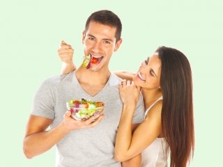 Young couple tasting a salad