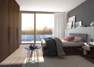 (foto2) Sempre di Lema: letto Theo (design Studio Kairos) con testiera rivestita in tessuto grigio leggermente trapuntato, Armadio al Centimetro Cea (design Marelli&Molteni) con ante a battente in rovere termotrattato dalla maniglia integrata, comodini Tip (design Daniel Debiasi - Federico Sandri) di rovere termotrattato con frontale finitura argilla sabbia e tavolino Mr. Zheng (design Roberto Lazzroni).