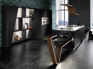 Un design fluido e suggestivo per il modello ergonomico Vision di Snaidero che si sviluppa intorno all'isola attrezzata a cui è collegato il tavolo design. Le ante sono in laccato opaco super matt nero puro. Il piano di lavoro è in acciaio inox satinato incrociato, quarzo black and more. Prezzo su richiesta. www.snaidero.it