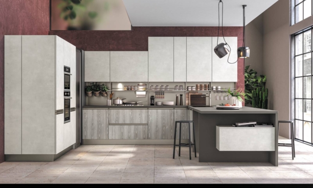 Plus Head di Lube è la cucina con penisola, aperta sul living, caratterizzata da un'armadiatura molto profonda, piano di lavoro unicolor grigio monsone finitura schiky Plus Head di Lube è la cucina con penisola, aperta sul living, caratterizzata da un'armadiatura molto profonda, piano di lavoro unicolor grigio monsone finitura schiky