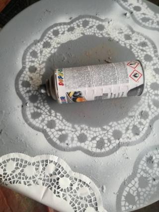 Per rifinire i bordi del tavolino appoggiate il sottotorta come mostrato in foto e spruzzate velocemente una velatura di bianco, procedete in questo modo di volta in volta sollevando e appoggiando il supporto di carta. Per rifinire i bordi del tavolino appoggiate il sottotorta come mostrato in foto e spruzzate velocemente una velatura di bianco, procedete in questo modo di volta in volta sollevando e appoggiando il supporto di carta.