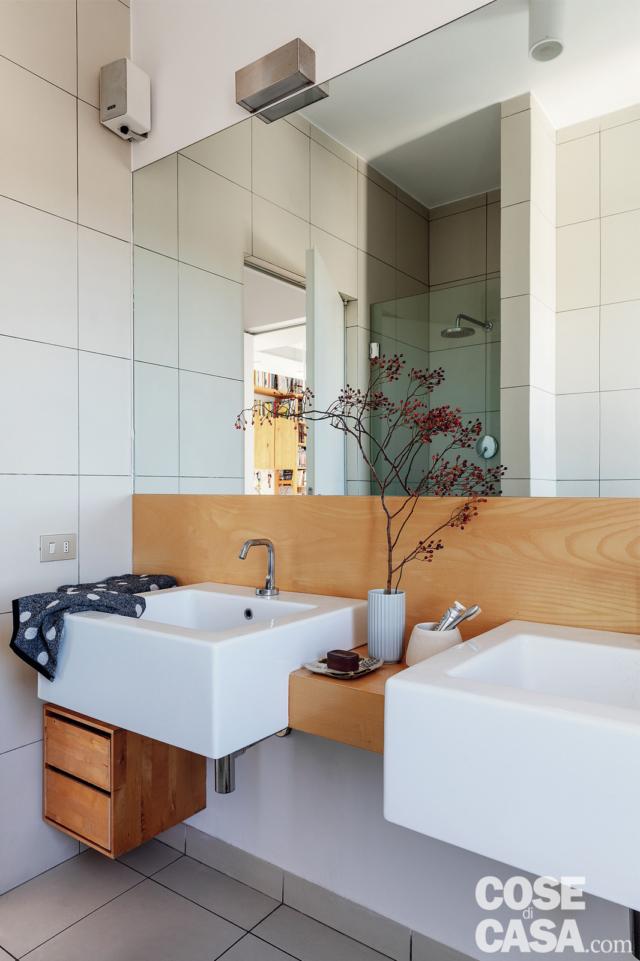 bagno, piastrelle in gres bianco, boiserie, specchio, mobile e lavabi sospesi, cassettiera in legno, piano d'appoggio centrale, vaso, ramo bagno, piastrelle in gres bianco, boiserie, specchio, mobile e lavabi sospesi, cassettiera in legno, piano d'appoggio centrale, vaso, ramo