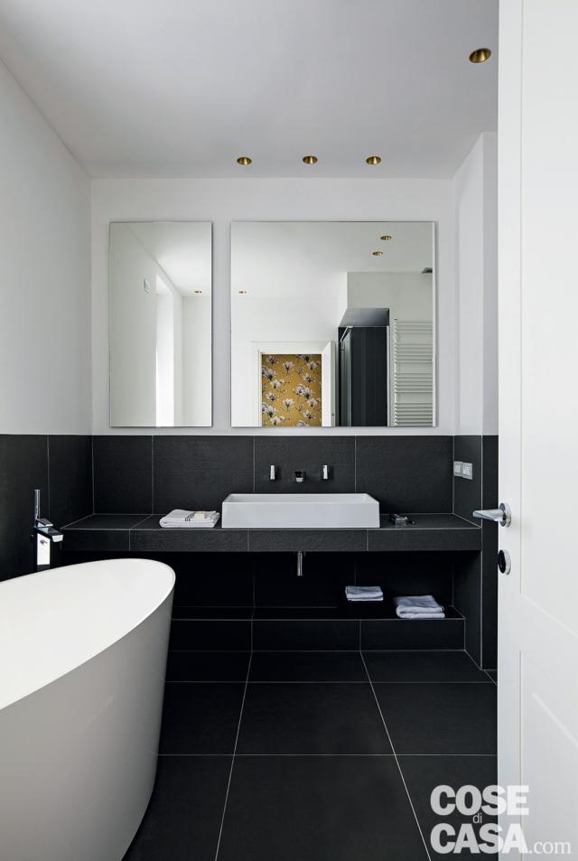 bagno della camera, specchi, faretti incassati, piano sospeso, lavabo da appoggio, rivestimenti in gres scuro, vasca freestanding, porta bagno della camera, specchi, faretti incassati, piano sospeso, lavabo da appoggio, rivestimenti in gres scuro, vasca freestanding, porta