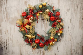 Christmas wreath on a rustic wooden front door. Christmas wreath on a rustic wooden front door.