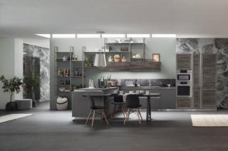 Le raffinate sfumature del grigio scuro per il modello Twin di Arrex che ha le colonne e i pensili in laminato effetto legno colore Okobo Dark; le basi invece sono in laminato monocolore tonalità Nickel. Le ante si aprono per mezzo del sistema a gola a “L” ; lo zoccolo in metallo nella finitura inox scandisce la composizione. Il top in laminato Hpl bordo Unicolor colore Cesare Brown armonizza e completa l'ambiente. La penisola è corredata di un pratico tavolo snack che aumenta la superficie di appoggio. Un modulo base da 60 cm, prezzo 136 euro + IVA. www.arrex.it