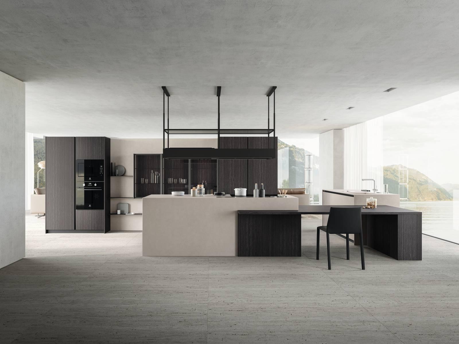 La cucina Zafferano di Valdesign si apre completamente sul living integrandosi perfettamente grazie alla parete organizzata con colonne, vetrine e mensole, coordinata con i colori delle due isole operative. Le basi, il top e la boiserie sono in Laminam Fokos sale, le colonne Logica sono in Nobilitato Eukalipto fossile come il lungo bancone che aumenta la superficie di lavoro e collega le due postazioni. I pensili Canvas hanno le ante in vetro trasparente grigio. Un modulo base (L 90 x P 57,5 x H 81,5 cm) con anta, prezzo a partire da 451 euro + IVA. www.valdesigncucine.eu La cucina Zafferano di Valdesign si apre completamente sul living integrandosi perfettamente grazie alla parete organizzata con colonne, vetrine e mensole, coordinata con i colori delle due isole operative. Le basi, il top e la boiserie sono in Laminam Fokos sale, le colonne Logica sono in Nobilitato Eukalipto fossile come il lungo bancone che aumenta la superficie di lavoro e collega le due postazioni. I pensili Canvas hanno le ante in vetro trasparente grigio. Un modulo base (L 90 x P 57,5 x H 81,5 cm) con anta, prezzo a partire da 451 euro + IVA. www.valdesigncucine.eu