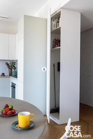 zona cottura del trilocale, colonna ripostiglio in laccato bianco, tavolo rotondo, tazza gialla, pavimento in parquet zona cottura del trilocale, colonna ripostiglio in laccato bianco, tavolo rotondo, tazza gialla, pavimento in parquet