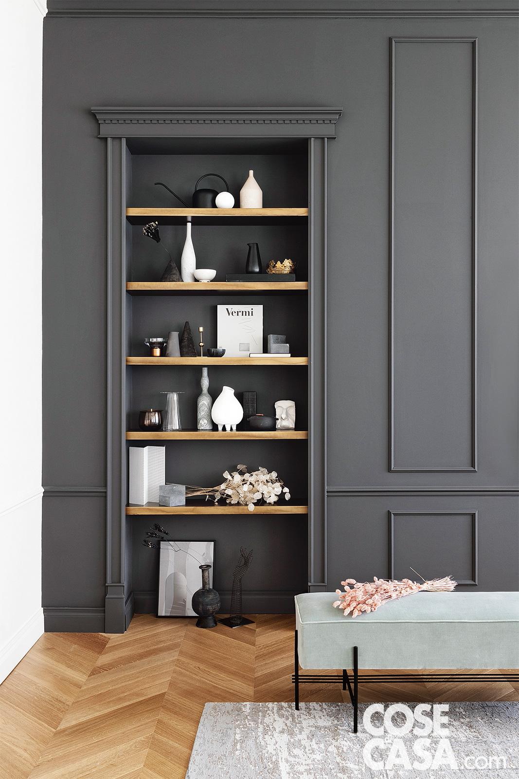 libreria in nicchia con boiserie grigia