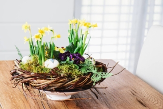 Easter table centerpiece decoration with daffodils and easter eggs Easter table centerpiece decoration with daffodils and easter eggs