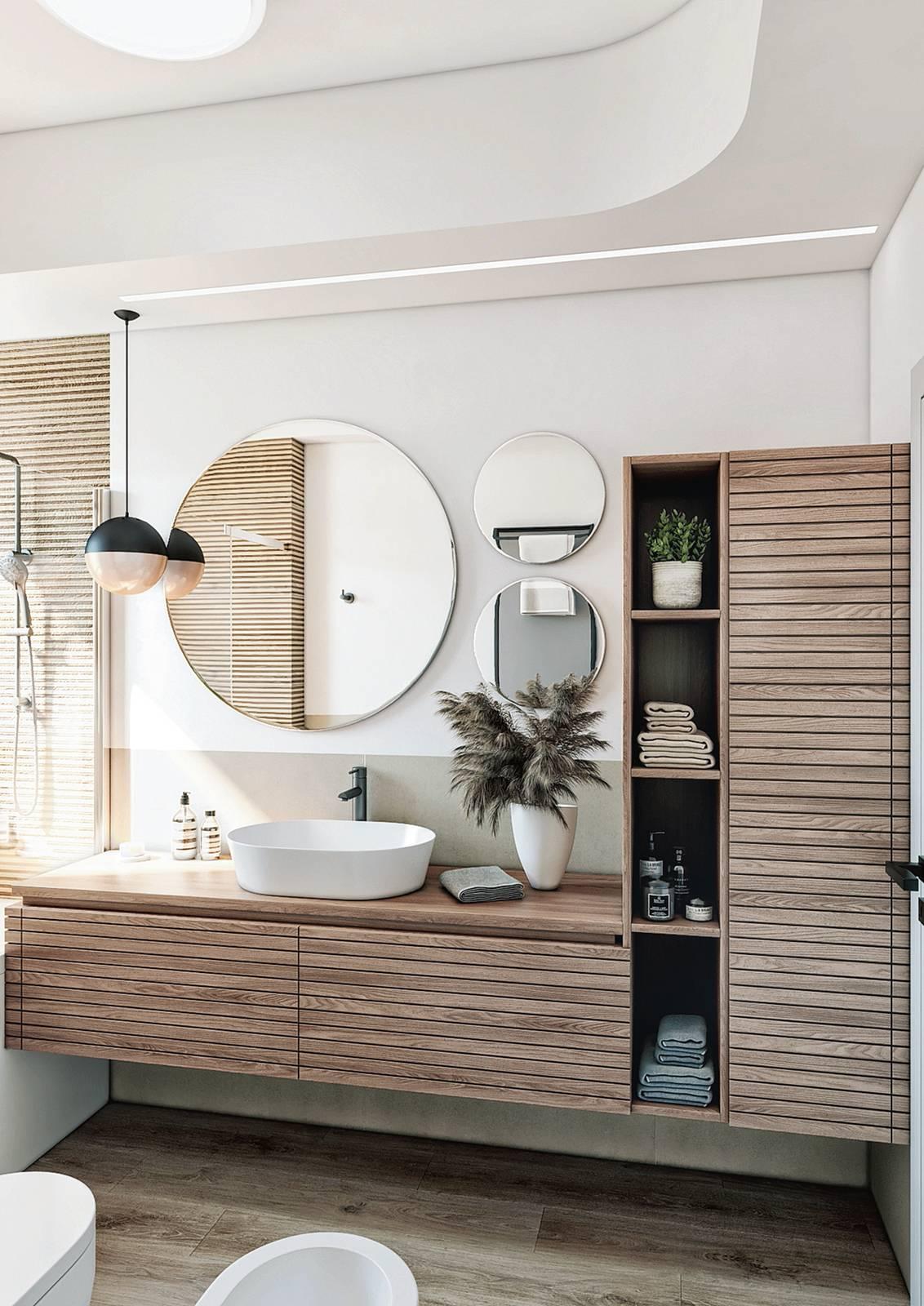 Scenografica e super funzionale, l'ampia zona della beauty routine si estende lungo circa 250 cm. Malgrado la dimensione importante, appare  leggera grazie alla scelta di moduli sospesi. Anche il motivo rigato che decora le ante degli elementi chiusi collabora all'impressione visiva. A completamento, gli accessori - dagli specchi alla lampada - giocano sul tema del cerchio.