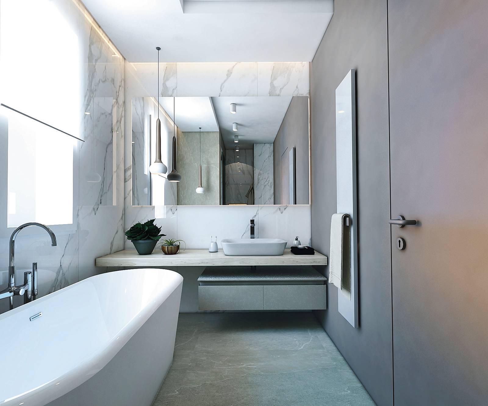Porta filo muro mimetizzata con la parete, superfici continue, linee squadrate sono i focus di questo progetto, che trova nelle rotonditÀ della vasca freestanding e delle lampade a sospensione un contrappunto felice al rigore dell'insieme