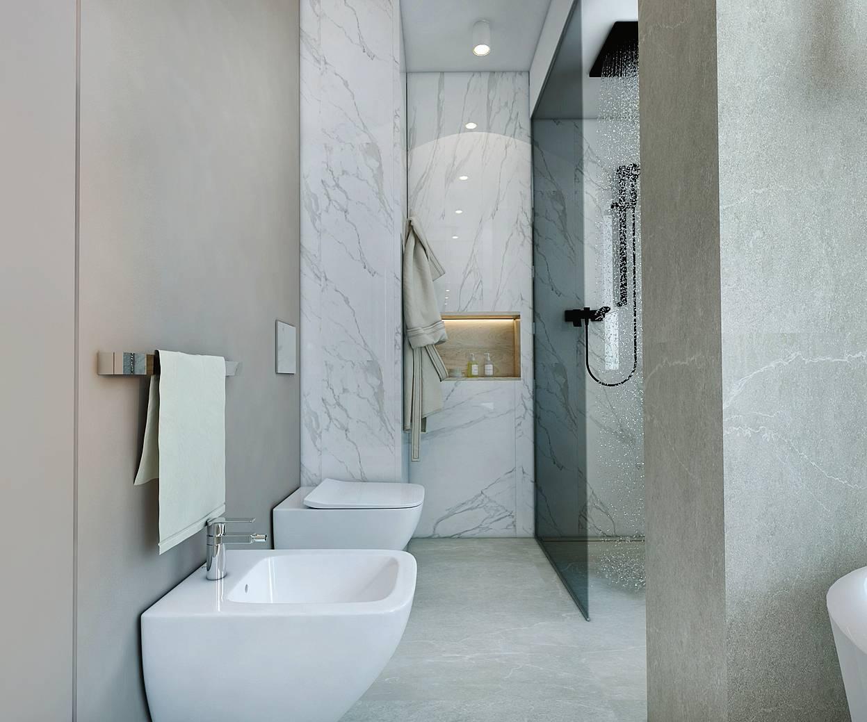 Nulla è lasciato al caso. Sul fondo dell'ambiente, accanto alla doccia, una nicchia portaoggetti, ricavata grazie a una controparete, è un elemento che attira lo sguardo. Complice anche una studiata illuminazione che le dà il giusto rilievo.