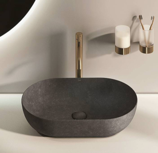 Rak-Skin di RAK Ceramics è realizzato in un composto ceramico
dalla superficie che richiama
il cemento. La finitura è Carbon Concrete, disponibile anche Blush, Grey e White. Il materiale permette di ottenere bordi sottili (5 mm)
ma resistenti. Misura L 55 x
P 35 x H 13 cm e costa 692 euro. www.rakceramics.com
