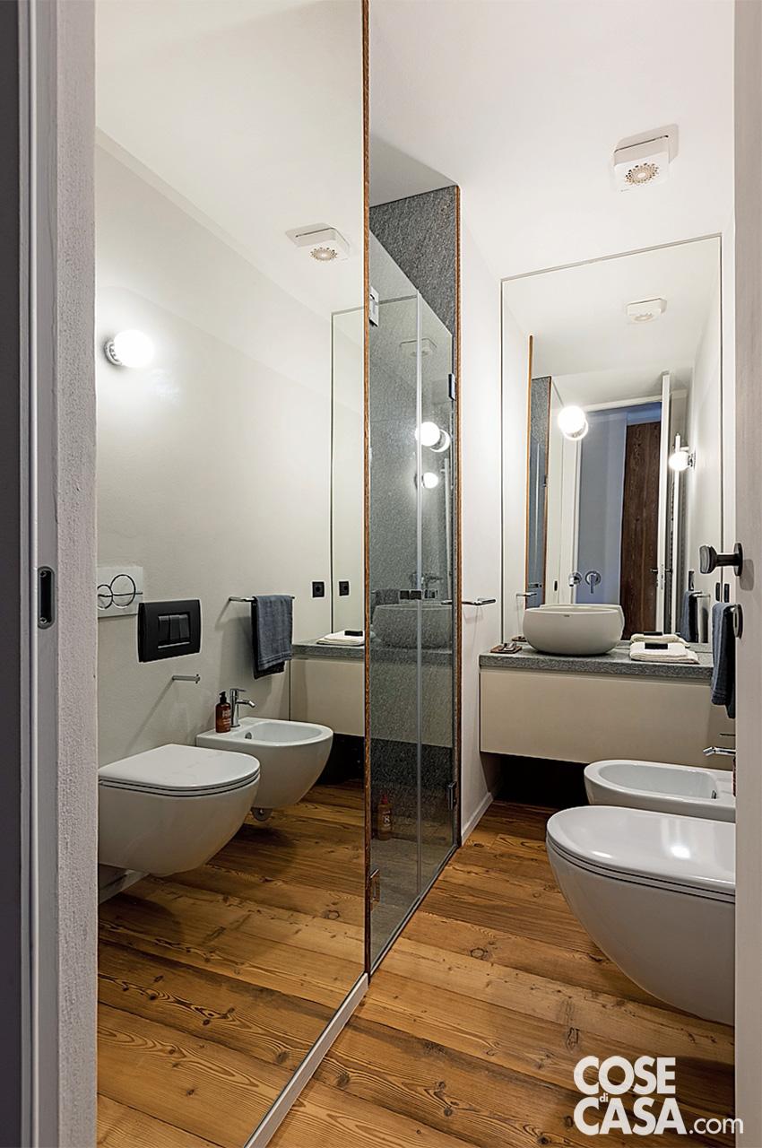 Nel bagno della camera matrimoniale la parete specchiata a sinistra, di fianco alla doccia, ne raddoppia visivamente la larghezza. Sanitari Sfera di Catalano, lavabo La Bacinelle di Ceramica Cielo. Asciugamani di La Fabbrica del Lino. Nel bagno della camera matrimoniale la parete specchiata a sinistra, di fianco alla doccia, ne raddoppia visivamente la larghezza. Sanitari Sfera di Catalano, lavabo La Bacinelle di Ceramica Cielo. Asciugamani di La Fabbrica del Lino.