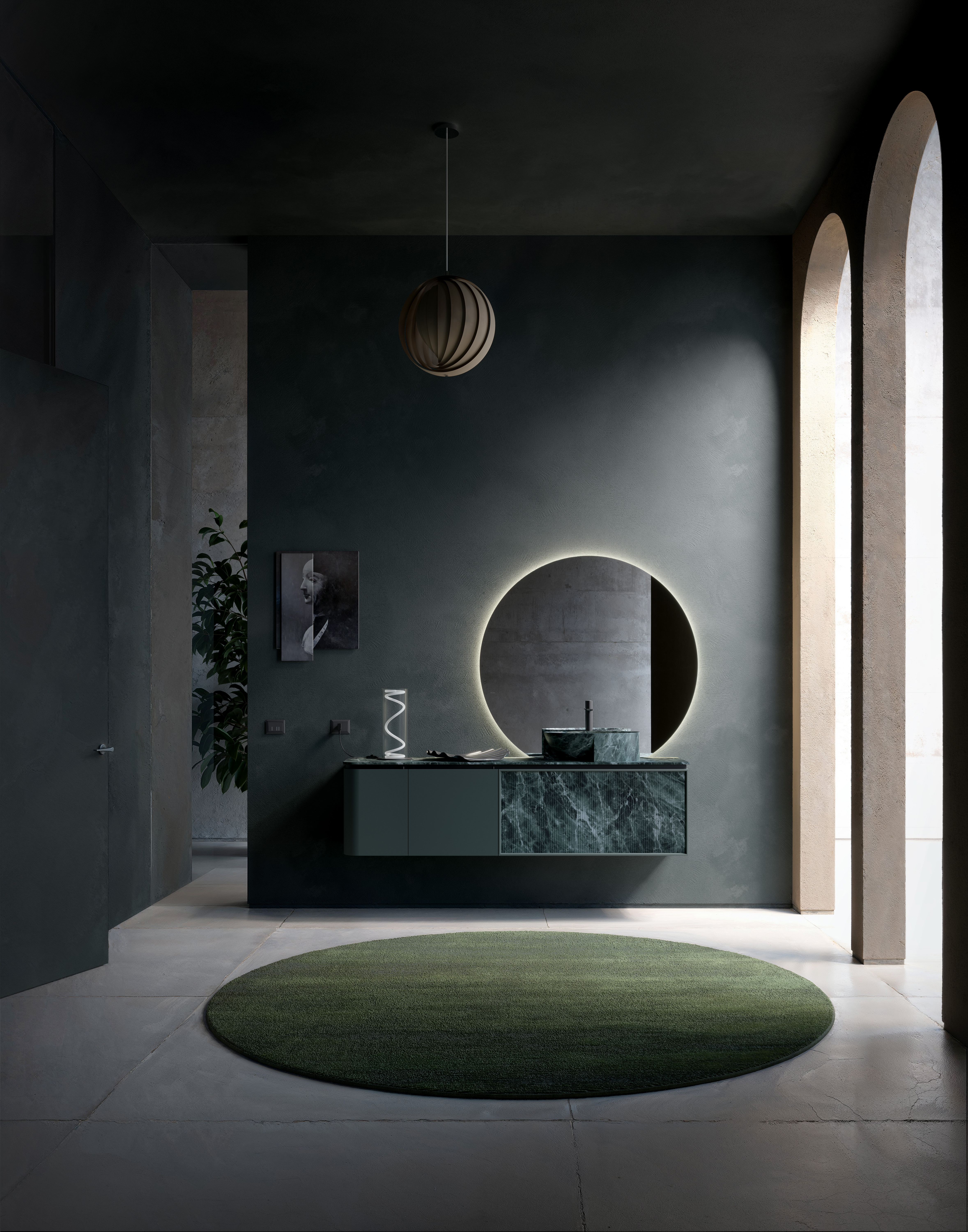 La collezione DES di Cerasa si presenta con un restyling. Laccata Ral 6012 opaco, si compone di un mobile con anta spessore curva sinistra che misura L 35 x H 48 cm, una base con cassetto da 50 cm e una base lavabo lunga 105 cm con frontale cassetto a telaio. Quest’ultimo ha rivestimento in resina Stone Verde Alpi 3D, come il piano e il rivestimento del lavabo Zefiro. Completa la composizione il grande specchio rotondo illuminato a LED. www.cerasa.it – Salone del Mobile, padiglione 10, stand B14-B16.