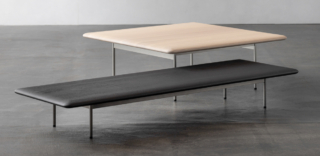 Un piano con una curvatura delicata, realizzato in massello di noce o rovere, per i tavolini MT coffee table di Ritzwell. Il top, quadrato o rettangolare, è sorretto da sottili gambe cilindriche in acciaio nella finitura naturale o verniciato grigio e nero. Sono disponibili in due altezze. https://www.ritzwell.com - Salone del Mobile, padiglione 09, stand B01-B03.