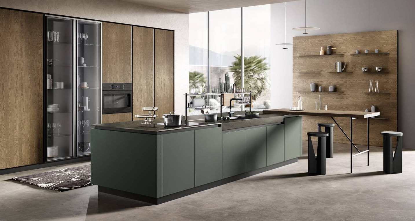 La composizione Venere 4 di Moretti Compact Cucine ha le colonne con le ante impiallacciate Rovere Yuta abbinate alle ante in vetro lucido Fumé; le ante sono arricchite dalle gole che corrono fra i vari moduli e mettono in evidenza i materiali. L’isola a centro stanza, integralmente laccata opaca color muschio con il piano di lavoro in laminam nella finitura ossido nero, è caratterizzata da un tavolo snack a sbalzo e dal sistema organizer a ponte isola modello Hang Top. La struttura, prezzo a partire da 183 euro + Iva. www.cucine.moretticompact.it La composizione Venere 4 di Moretti Compact Cucine ha le colonne con le ante impiallacciate Rovere Yuta abbinate alle ante in vetro lucido Fumé; le ante sono arricchite dalle gole che corrono fra i vari moduli e mettono in evidenza i materiali. L’isola a centro stanza, integralmente laccata opaca color muschio con il piano di lavoro in laminam nella finitura ossido nero, è caratterizzata da un tavolo snack a sbalzo e dal sistema organizer a ponte isola modello Hang Top. La struttura, prezzo a partire da 183 euro + Iva. www.cucine.moretticompact.it