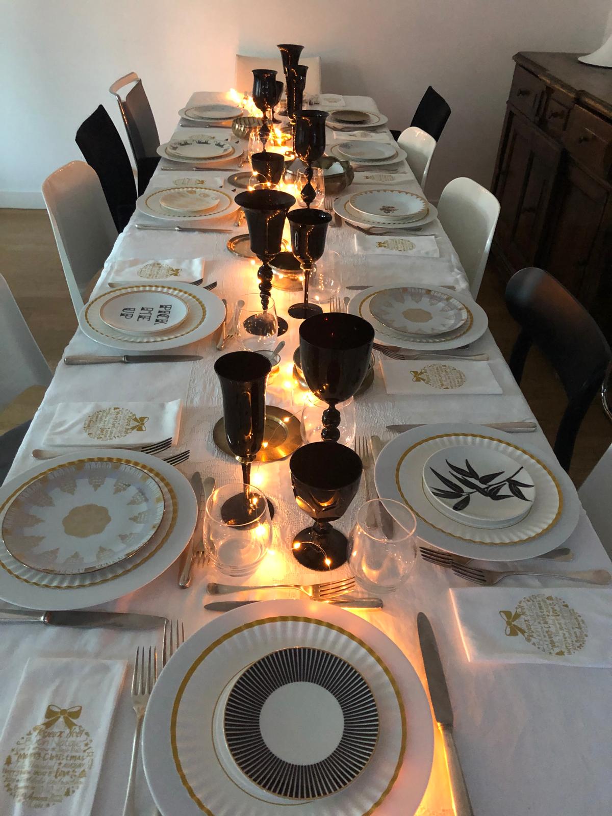 Tavola di Capodanno con piatti diversi e bicchieri neri super chic