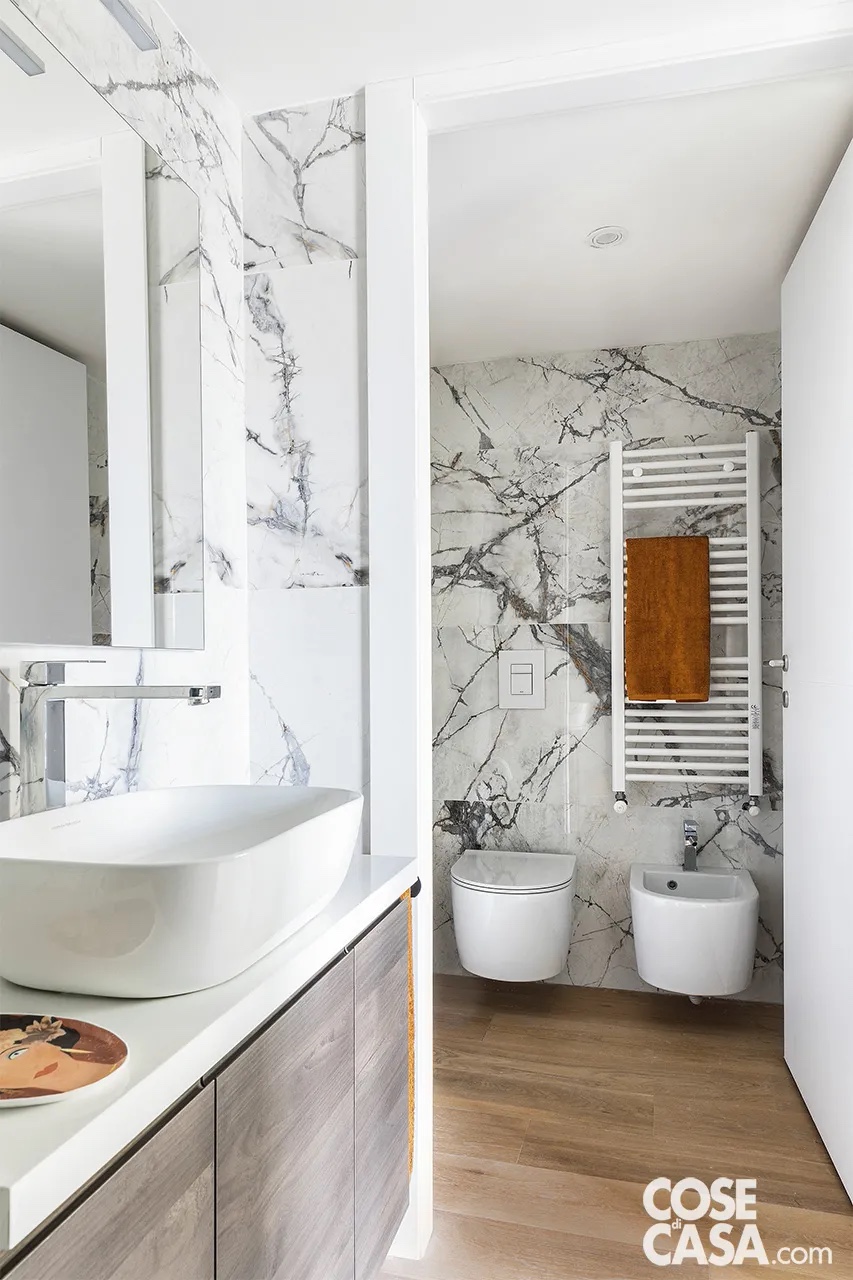 Vero parquet e piastrelle in finto marmo a parete per il bagno con mobile lavabo in legno. Foto: Alessandra lanniello. Progetto d’Interior: Officina Interior. Vero parquet e piastrelle in finto marmo a parete per il bagno con mobile lavabo in legno. Foto: Alessandra lanniello. Progetto d’Interior: Officina Interior.