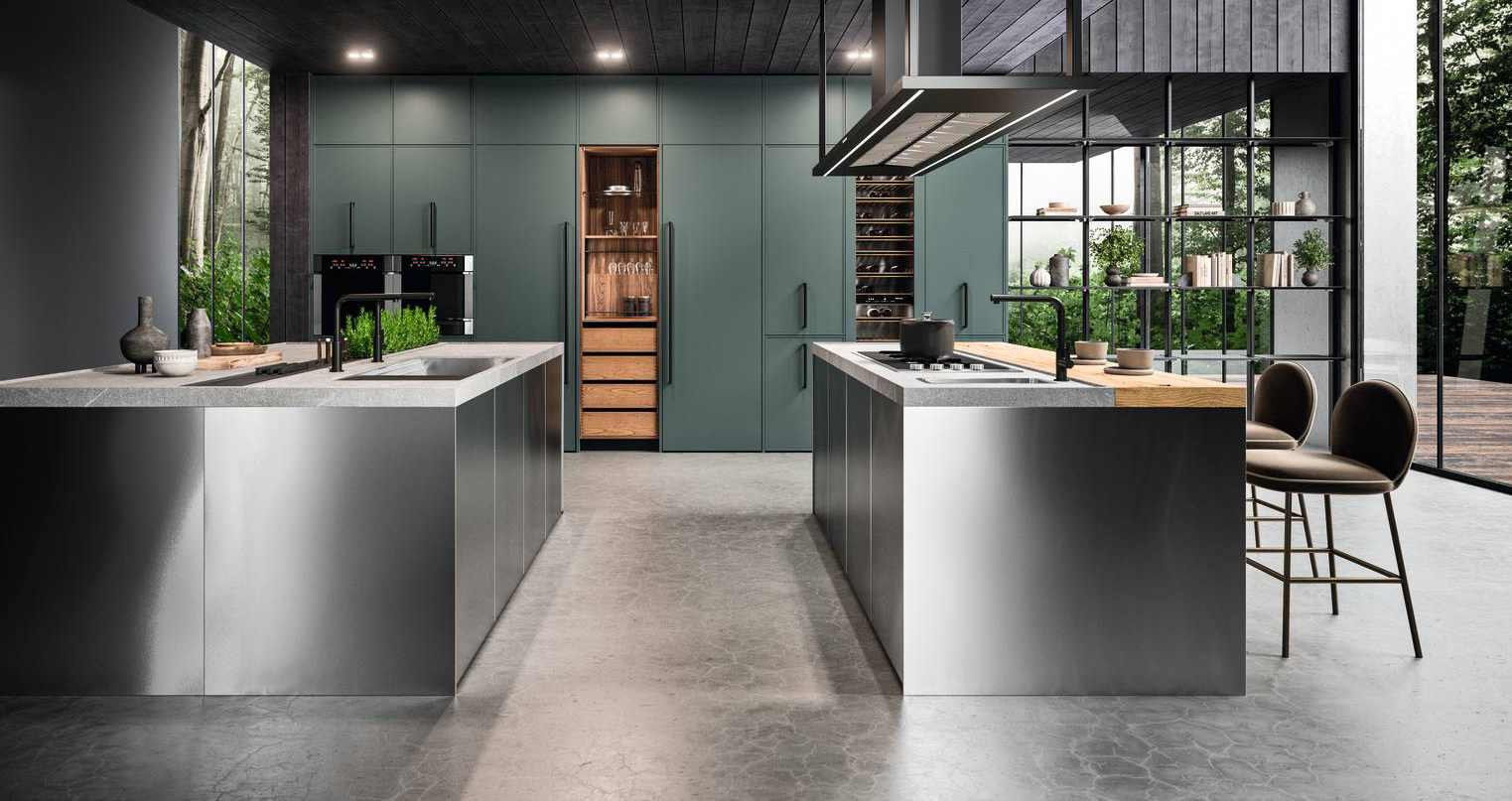 Due blocchi isola indipendenti per l'ampia composizione Guadalupe di ARAN Cucine: una attrezzata con la zona lavaggio con vasca in acciaio inox, l'altra con quella cottura e un piano polifunzionale in legno di recupero E-WOOD. Le ante delle colonne che compongono la grande armadiatura a parete che accoglie gli elettrodomestici, la dispensa e la cantinetta sono realizzate in laccato Verde comodoro. Un modulo base da 60 cm, prezzo 746,64 euro. www.arancucine.it