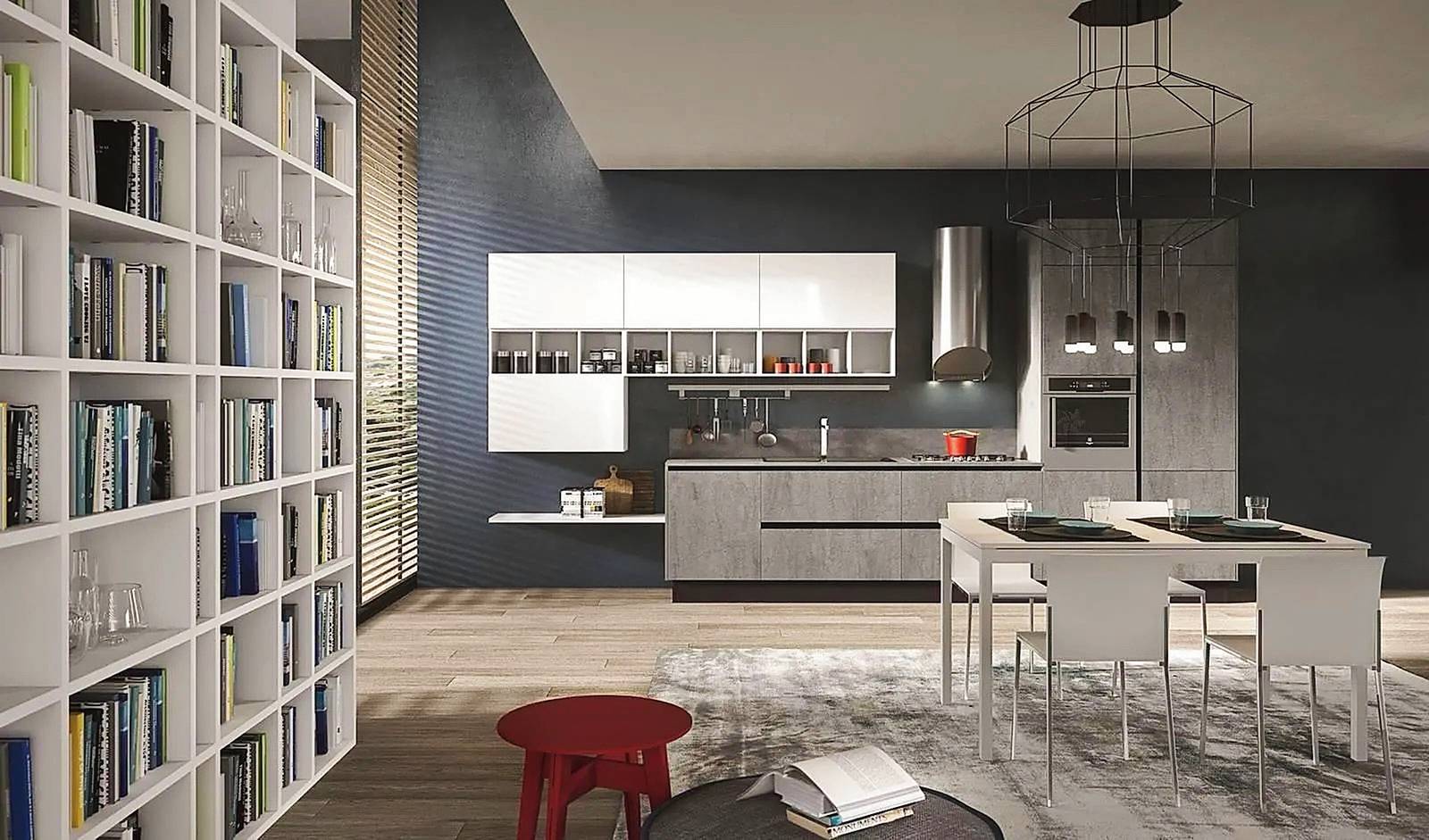 Il grigio e il bianco - rappresentato dai pensili e dall'area pranzo con tavolo e sedie - lavorano in sinergia armoniosa. Qui il rapporto è a favore del grigio, utilizzato non solo per la composizione della cucina (Bijou di Aran Cucine, www.arancucine.it) ma soprattutto per la parete di fondo, con un effetto industrial. Facendo prevalere il bianco, l'insieme apparirebbe invece più delicato e soft. 