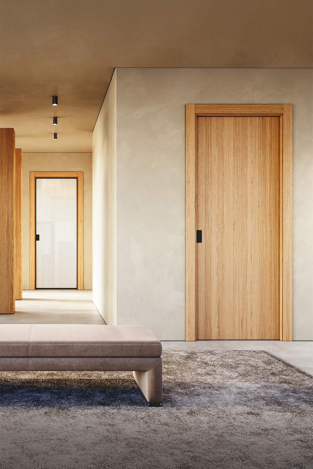 Nell’immagine, in primo piano, il modello Liss qui proposto nella nuova finitura Rovere Alba. Sullo sfondo, modello Cristal Frame battente della collezione Cristal con cristallo BIT 03 Satinato Bianco con profilo nero. Su entrambe maniglia Wave Nera.