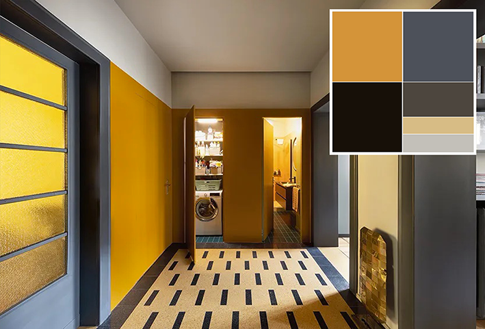 L'ambiente, giocato sui contrasti cromatici, distribuisce tutti gli ambienti: lo studio, con porta vetrata originale recuperata e riverniciata, e la camera da letto a sinistra, lavanderia in nicchia e bagno di fronte, zona giorno a destra. Foto: Barbara Corsico. Progetto: homarchitetti di Stefania De Paola, Roberta Massetti, Sabrina Saldo con Ottavia Giannone.