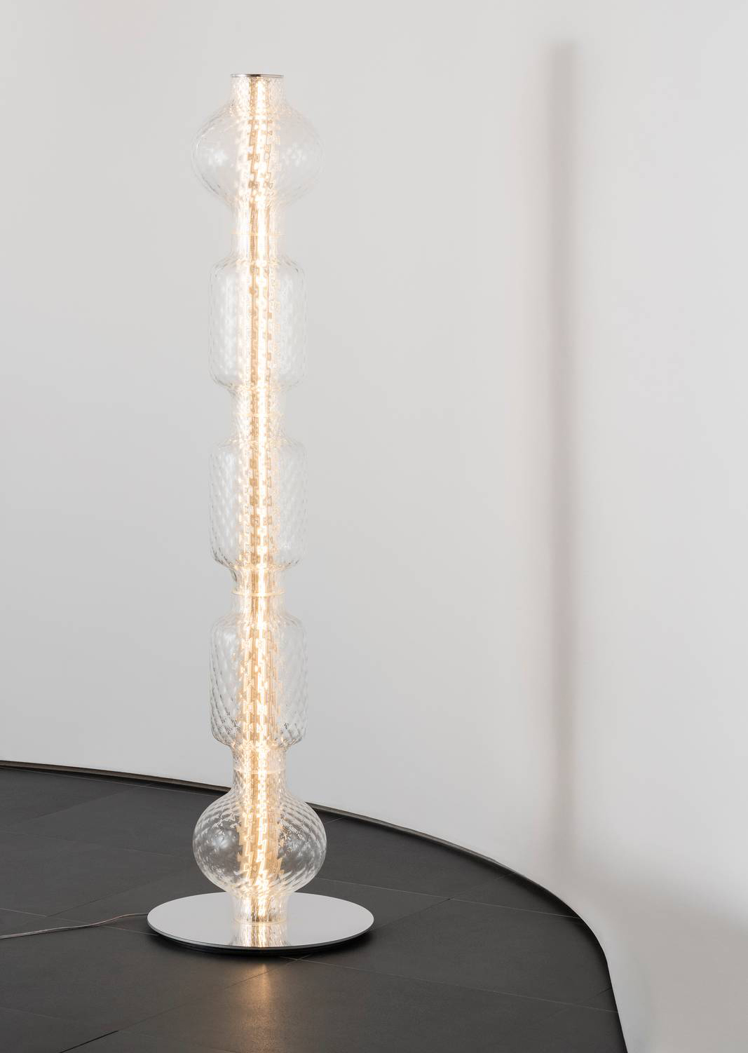 La lampada Alambicco di Artemide nella nuova versione da terra gioca con le trasparenze grazie alla struttura in alluminio estruso, che ospita i circuiti LED, circondata da un cilindro in vetro rigato che rifrange la luce. I diffusori sovrapposti di forma rotonda sono ispirati dalla tradizionale tecnica vetraria del “balloton”. https://www.artemide.com/it/home – Euroluce, padiglione 4, stand C15/D10. La lampada Alambicco di Artemide nella nuova versione da terra gioca con le trasparenze grazie alla struttura in alluminio estruso, che ospita i circuiti LED, circondata da un cilindro in vetro rigato che rifrange la luce. I diffusori sovrapposti di forma rotonda sono ispirati dalla tradizionale tecnica vetraria del “balloton”. https://www.artemide.com/it/home – Euroluce, padiglione 4, stand C15/D10.