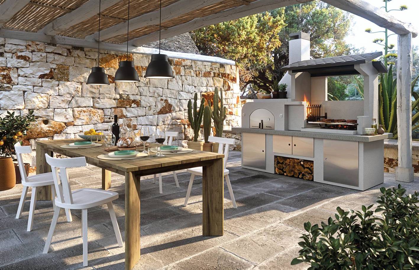 Il barbecue a legna Antille di Palazzetti in Giardino ha ampia area grill (da 76x55 cm regolabile su 2 altezze) e forno pizza in refrattario. Il focolare con braciere laterale facilita le operazioni di cottura e di caricamento della legna e consente l’uso completo dell’area grill. Il piano di lavoro è in Marmotech levigato finitura granito grigio e ha portina in acciaio inox con pratico termometro e maniglia antiscottatura. Misura L 255 x P 90 x H250 cm. Prezzo da rivenditore. Prezzo di listino 4.300 euro. ingiardino.palazzetti.it