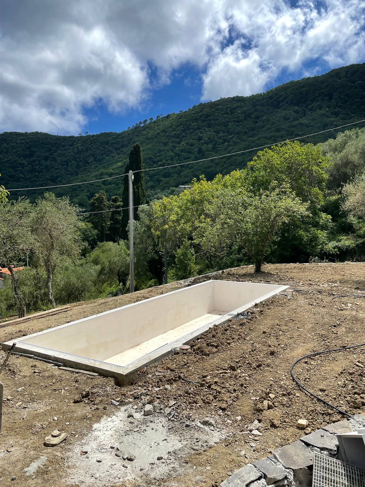 Un’altra vista della vasca di grande formato, rettangolare, con il bordo, in mezzo al prato che ancora non è stato seminato. Un’altra vista della vasca di grande formato, rettangolare, con il bordo, in mezzo al prato che ancora non è stato seminato.