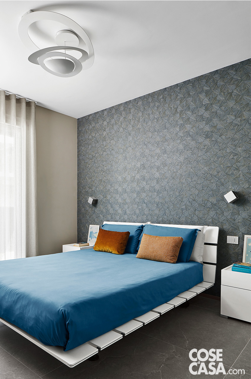 camera da letto con parete grigia