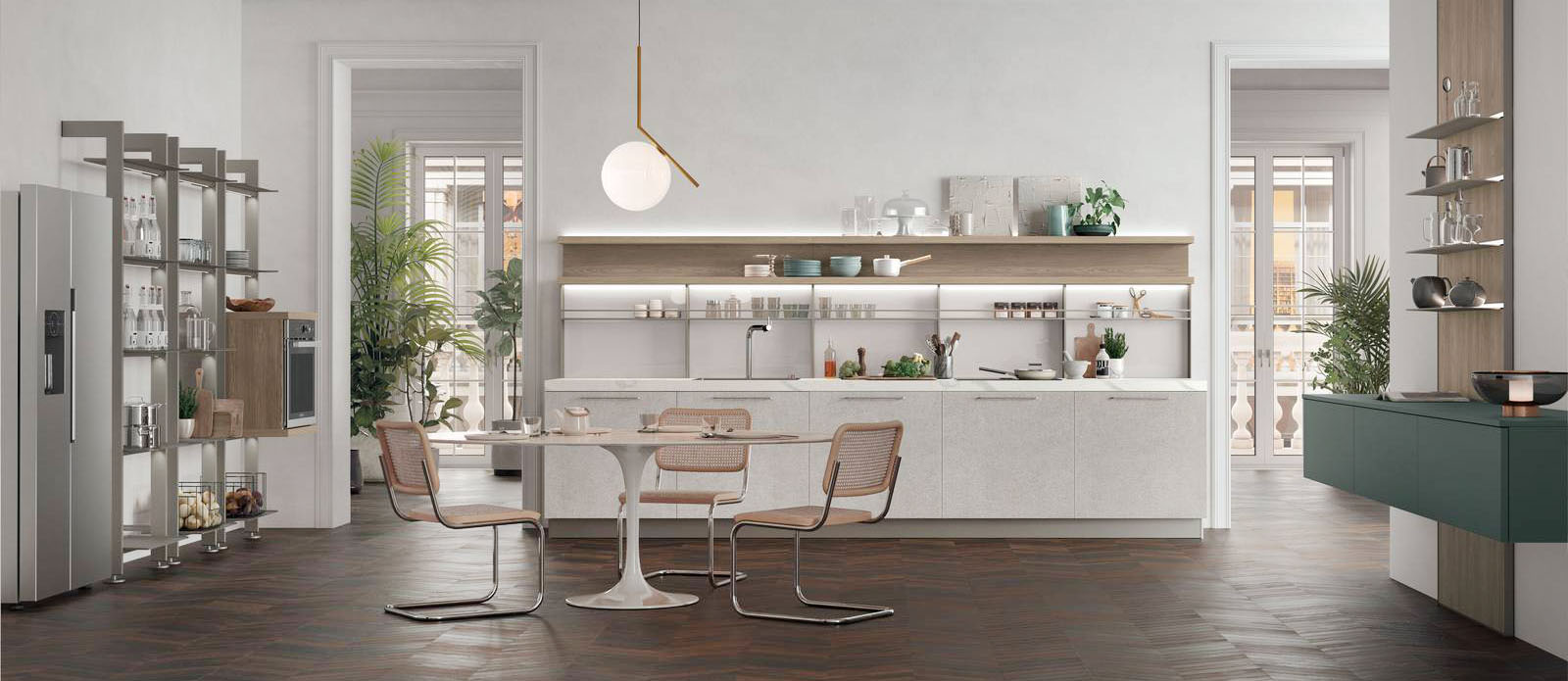 Si sviluppa lungo la parete la composizione Young di Stosa Cucine che ha lo spazio tra le basi attrezzato con lo schienale Combo Line che è reso funzionale dal vetro e dalle sponde in metallo. Le ante nella luminosa finitura Pietra Ghiaia è “scaldata” dalle mensole in Noce Marino. Il top è realizzato in HPL Calacatta. Il forno trova posto nella libreria in metallo a muro Giostra. Un modulo base da 60 cm, prezzo a partire da 150 euro + IVA. https://www.stosacucine.com