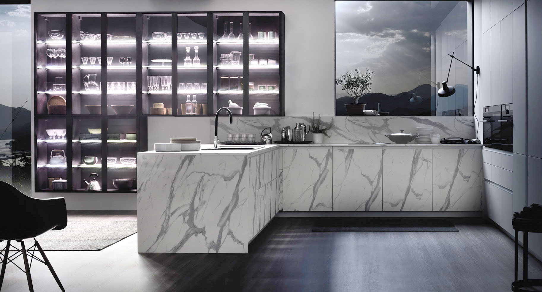 Scenografici e decorativi gli elementi della vetrina sospesa Officina, con il telaio antracite e vetro fumé, che trova posto sulla parete della cucina con penisola Urban Calacatta di Arrex. Le basi, con volume XXL, in laminato effetto marmo, come il piano e lo schienale, si contrappongono alle colonne Loft2.2 Soft laccato Bianco. Un modulo base da 60 cm, prezzo 321 euro + Iva. https://www.arrex.it