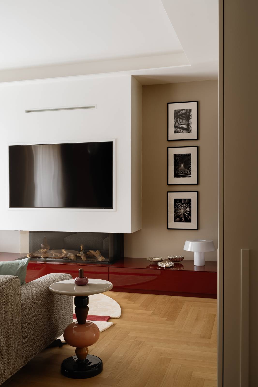 Dettaglio della parete di fronte al divano con biocamino e tv