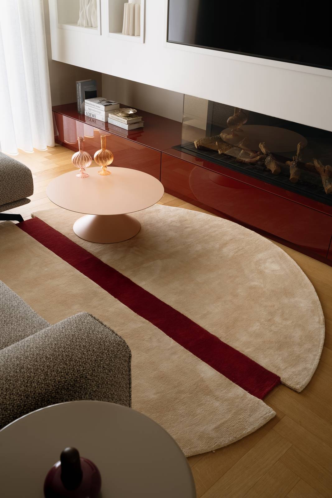 Dettaglio del tappeto beige con strisce rosso scuro in salotto