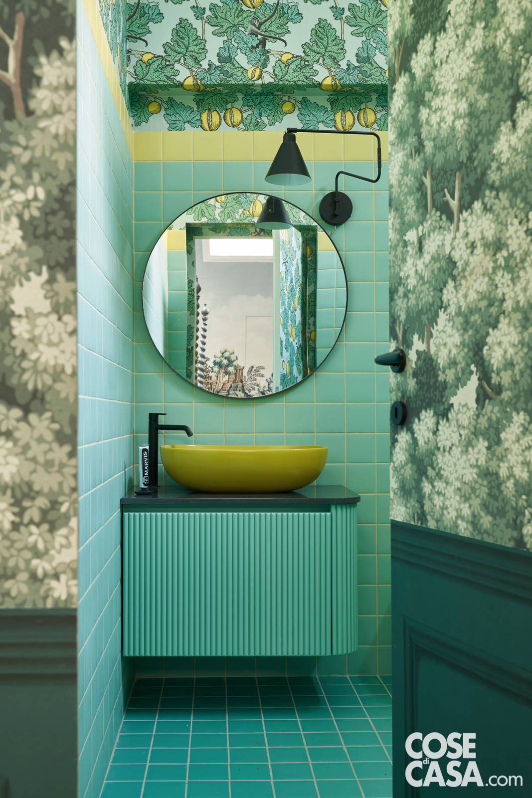 L'ingresso in bagno è un altro colpo di scena. Declinato nei toni del verde, delicati e rilassanti, propone un'interessante combinazione di finiture. Le piastrelle in ceramica
tinta unita salgono dal pavimento sulle pareti fino a incontrare il soffitto, tappezzato con una fantasia che nuovamente celebra
la natura. Il risultato è
un effetto scatola
con "coperchio" décor.
Progetto d'Interior: Nap Atelier, Via Privata della Braida 1, Tel. 02/796861, Milano - www.napatelier.com
Foto: Fabrizio Cicconi/Living Inside - Styling: Francesca Davoli