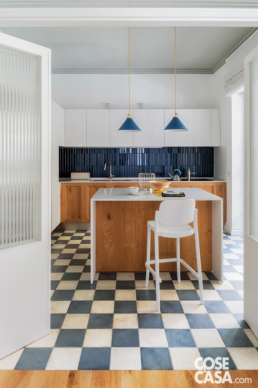 cucina bianca e legno con pavimento a scacchi bianco e eblu