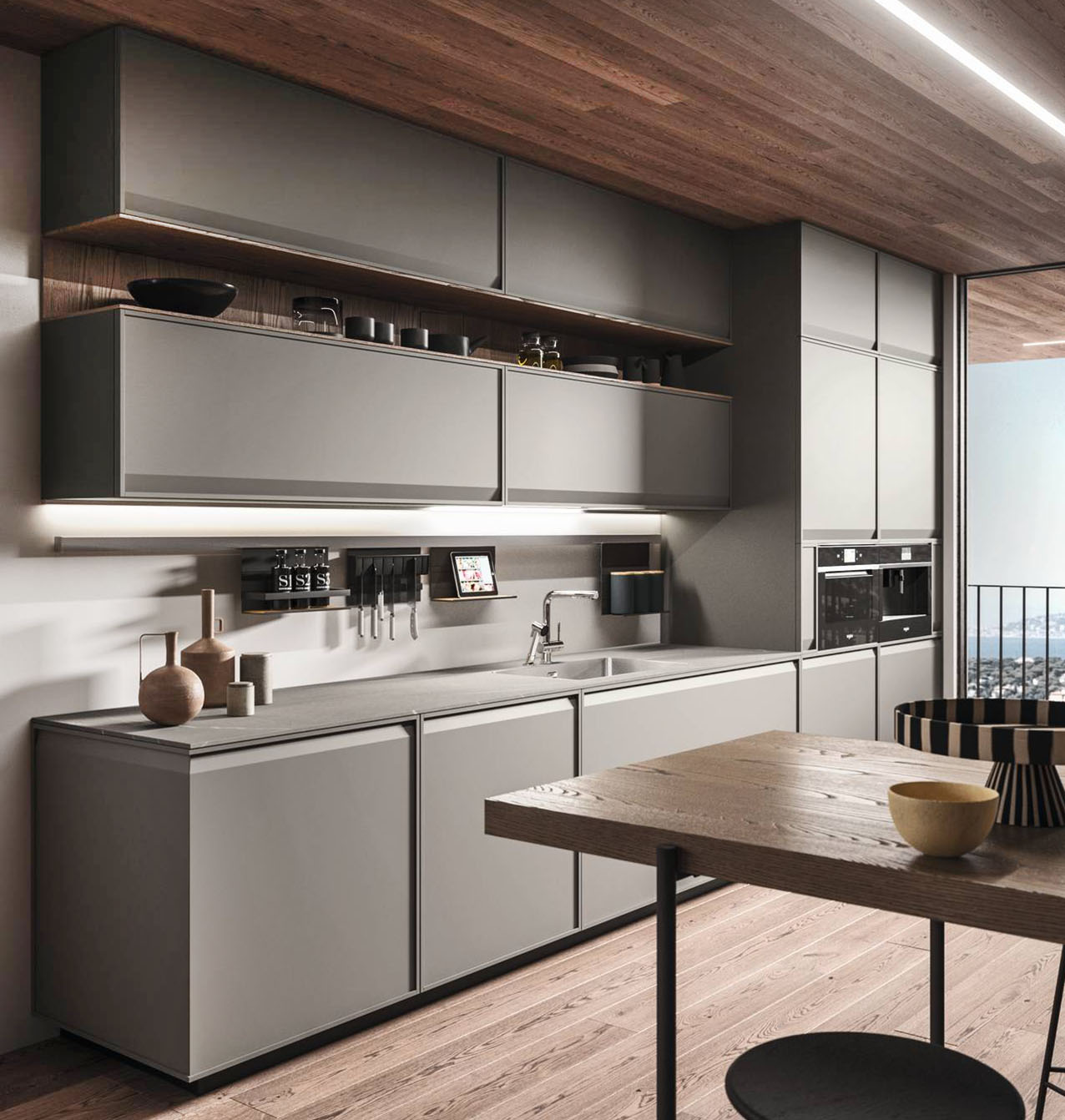 Si sviluppa a parete la cucina open space Ak_07 di Arrital che è caratterizzata dalla presenza di pensili a sviluppo orizzontale. Le ante lisce in laccato Sand Grigio Londra hanno il telaio a cornice sottile realizzato in legno massello e dotato di una pratica maniglia integrata. Il vano a giorno tra i pensili in Castagno Royal mette in risalto la colorazione delle ante. Prezzo su richiesta. https://www.arrital.it