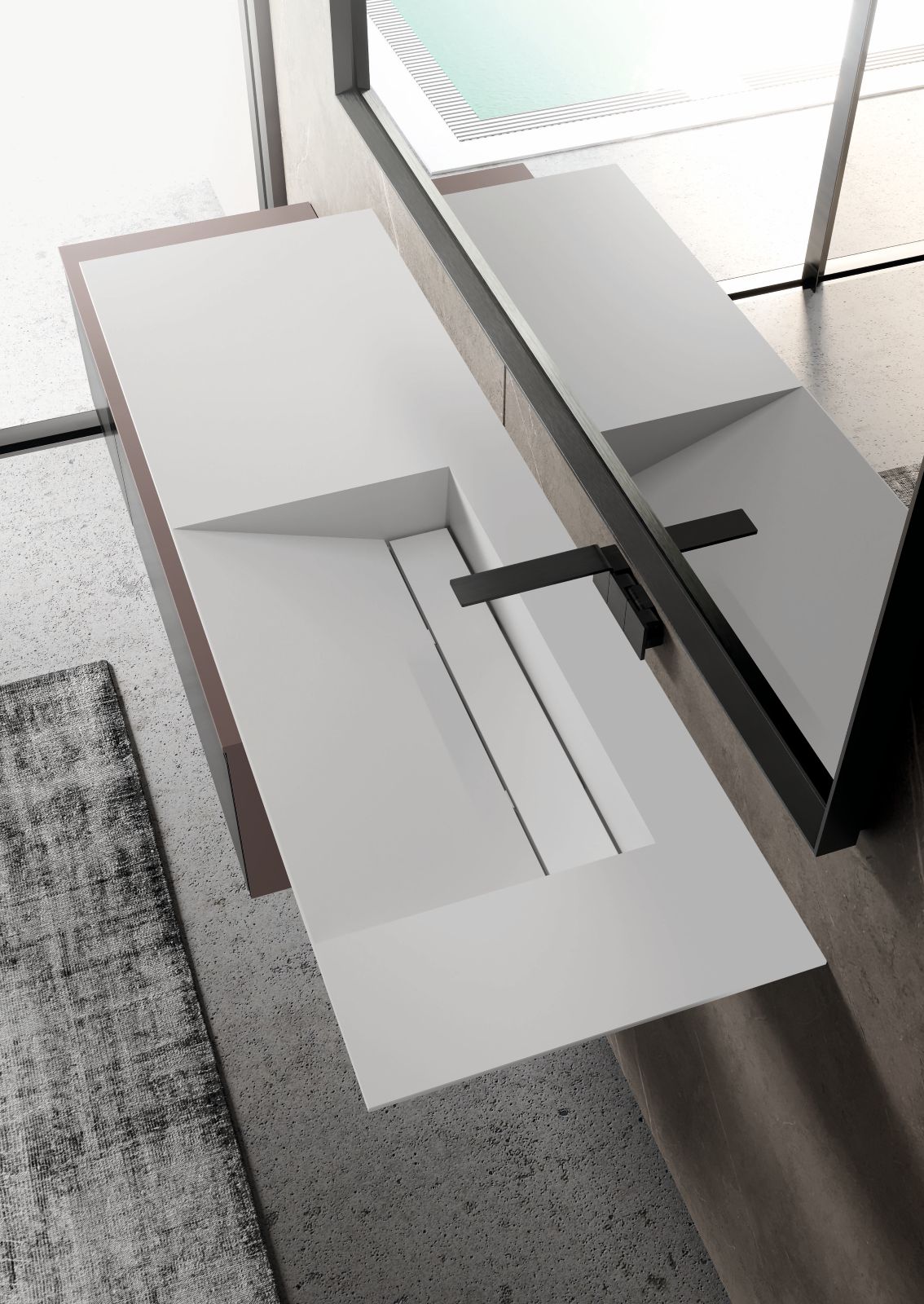 I top 52° di Ideagroup hanno bordi laterali e frontali inclinati e si presentano in svariati materiali e finiture: Gres, Corian Fenix, Hpl Unicolor, Rovere fossile ed Essenze naturali. Realizzati con uno spessore di 6 cm e installabili sospesi, sono disponibili con differenti tipologie di vasche integrate nel caso del Corian e con lavabi soprapiano per tutti gli altri materiali. I modelli in legno fossile sono realizzati con legno proveniente da tronchi rinvenuti nelle paludi, fiumi o laghi dell’Europa sudorientale, depositati in profondità perché il flusso dell’acqua e la qualità del terreno ne conferiscano la durezza e la resistenza che lo caratterizzano. Una volta estratto, il tronco subisce un processo di essicazione e il risultato spesso presenta molte imperfezioni di colore e forma. I modelli in Corian sono gli unici disponibili con vasche integrate, realizzate appositamente per questa tipologia di lavorazione inclinata. Sono realizzate con piletta sempre aperta inclusa, nascosta da una tavoletta removibile posta sulla lunghezza della vasca. Prezzo al metro lineare del top in rovere fossile, che misura L 145 x P 52 cm, 1.643 euro. Prezzo al metro lineare del top in gres, che misura L 181,2 x P 52 cm, 912 euro. Prezzo al metro lineare del top in Corian, che misura L 160 x P 50 cm, con vasca singola 1.363 euro, con vasca doppia 2.452 euro. www.ideagroup.it