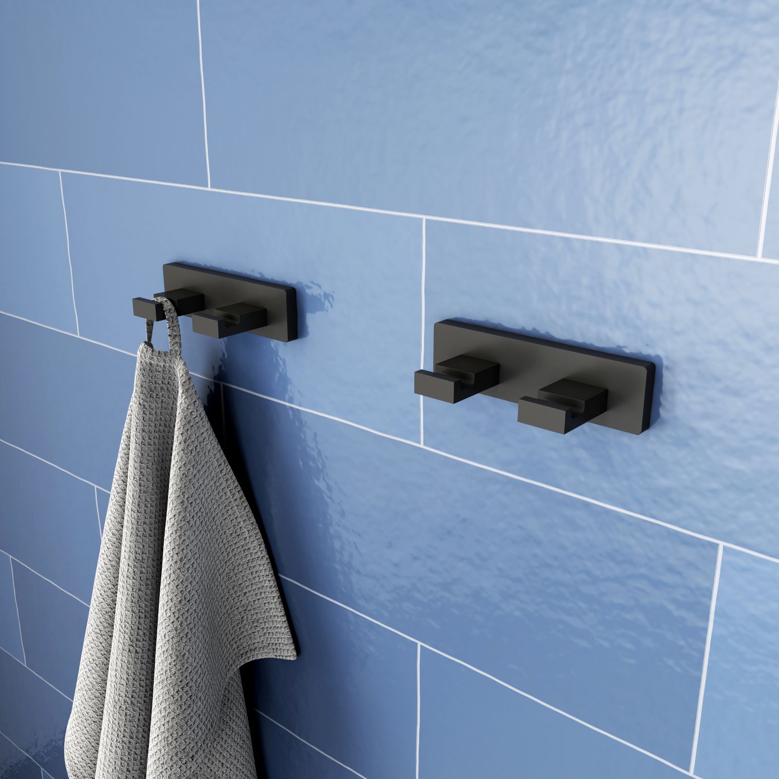 È in metallo il doppio gancio asciugamani Viverso x evolution di Reuter dalla forma squadrata e nella finitura nero opaca. Misura L 11 x P 4,5 x H 3 cm. Prezzo 39,38 euro. Si incolla con un kit adesivo specifico acquistabile a parte. www.reuter.com