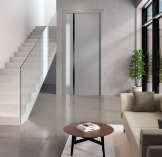 La porta modello NM00 della linea Nidio di Flessya è caratterizzata dal montante in massello, elemento dalla doppia valenza nella versione scorrevole, funzionale ed estetica. La rientranza rifinita con una laccatura lucida, serve a sostituire la maniglia ad incasso edona un tocco raffinato alla porta. In foto in finitura laccato RAL 9022 con inserto nero, misura L 80 x H 210 cm ed il prezzo è 1.288 euro + Iva. www.flessya.com