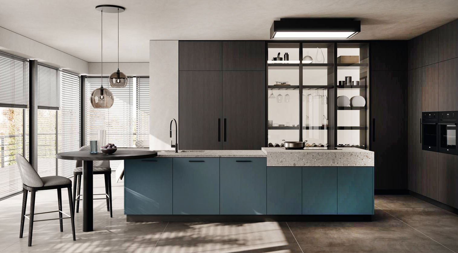 Le ante in laccato opaco Verde Ottanio delle basi fanno “spiccare” l'isola nella cucina Moda di Scavolini che è arredata con una serie di colonne con le ante in decorativo Quercia Brownie e con le ante a telaio in Alluminio, finitura Grigio Antracite, con vetro fumé trasparente e lo schienale luminoso Solaris Back. La grande isola ha il piano in gres Pietra d'Iseo Ceppo su cui trovano posto il lavello e il piano a induzione; lateralmente è presente il piccolo piano colazione in laminato Burnt Wood. Prezzo su richiesta. https://www.scavolini.com