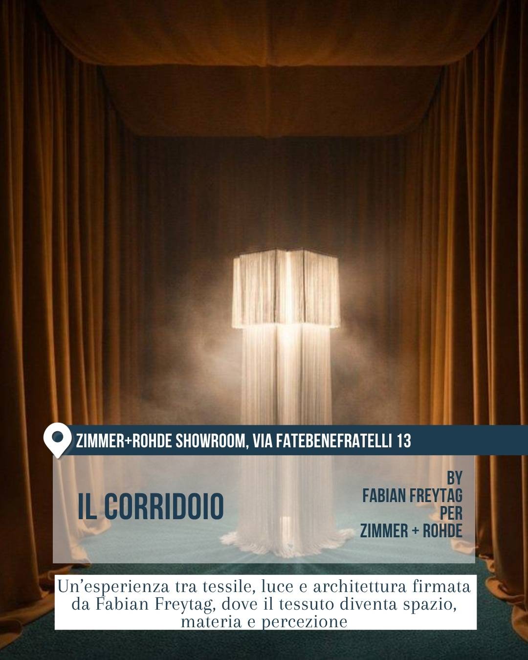 Fuorisalone 2026 a Milano: installazione “Il Corridoio” nello showroom Zimmer + Rohde, via Fatebenefratelli 13, di Fabian Freytag per Zimmer + Rohde. Spazio scenografico composto da tende color bronzo e una lampada tessile luminosa al centro, immersa in una luce soffusa. Il progetto esplora il rapporto tra tessuto, architettura, luce e percezione.