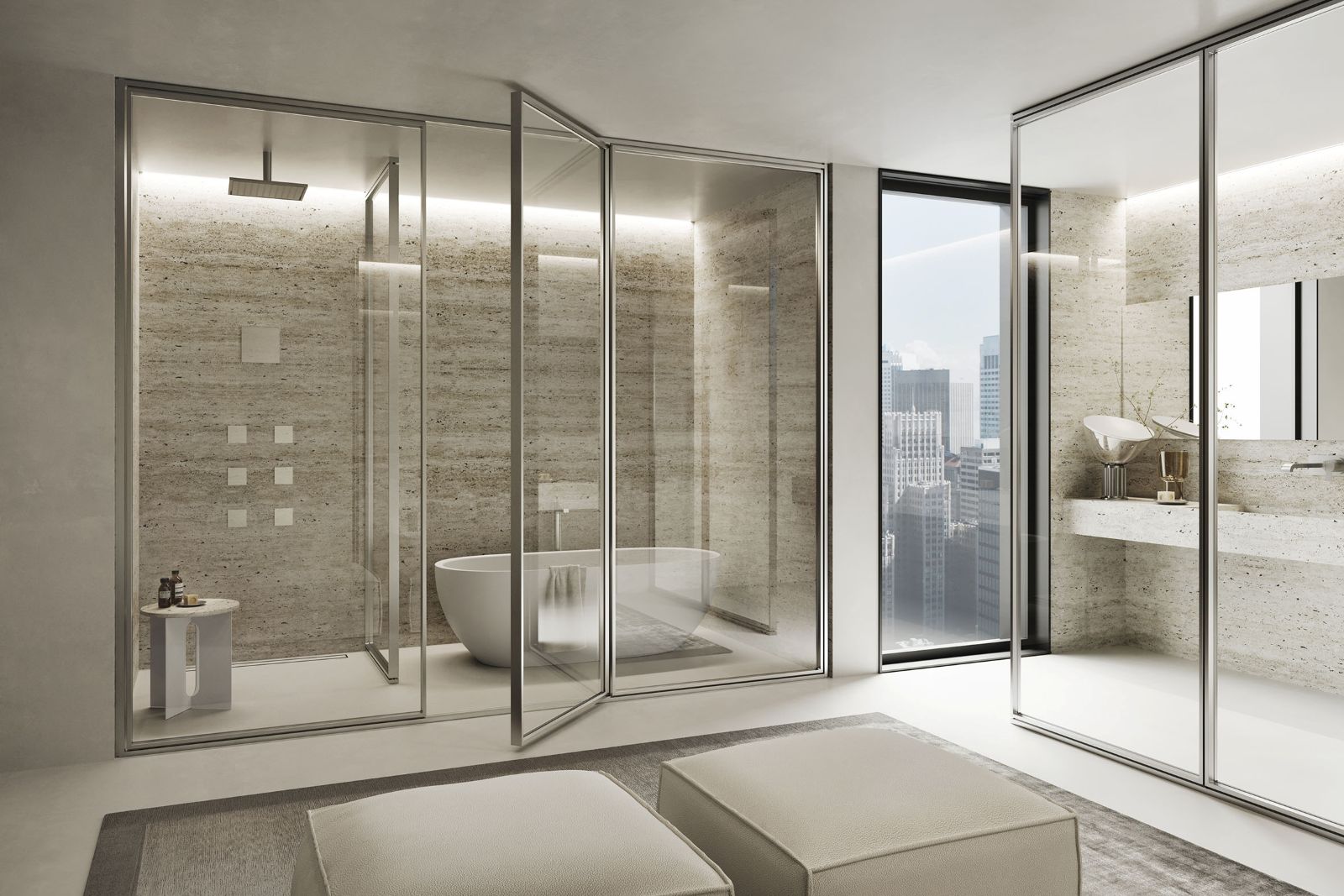 Il Sistema Parete Domino di Vismaravetro si declina in soli quattro elementi base, due porte (a battente e a bilico) e due pannelli fissi che danno vita a svariate configurazioni per la zona doccia. Le porte a battente possono aprirsi verso l’esterno o l’interno; quelle a bilico, grazie al perno decentrato, permettono un passaggio più ampio. Il sistema può essere installato a soffitto, attraverso un profilo dedicato, oppure a un’altezza libera in modalità autoportante. È disponibile in un’ampia gamma di finiture per vetri e profili in alluminio. In foto modello in cristallo trasparente con profili in finitura acciaio spazzolato. www.vismaravetro.it – Salone del Mobile 2026, padiglione 10, Stand A15/A19.