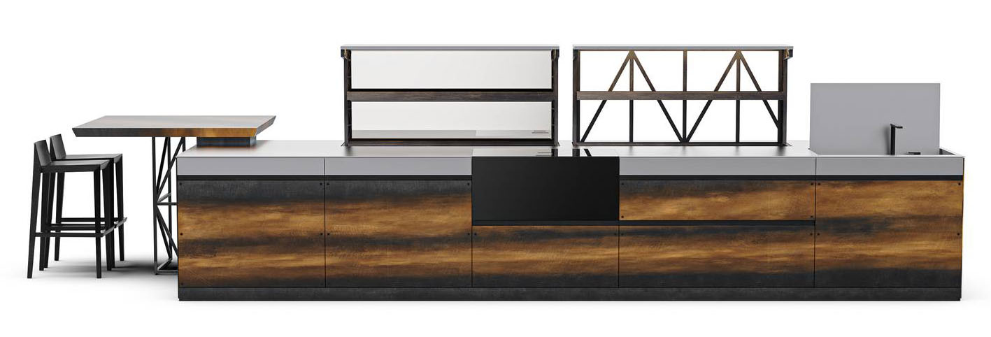 La cucina Sei di Euromobil viene reinterpretata attraverso l'isola monolitica e le ante con una venatura in bilia che prosegue senza interruzioni lungo l’intero fronte. Le viti in inox brunito, che uniscono il pannello di finitura al resto dell’anta, non vengono nascoste, ma si trasformano in elementi decorativi. Il top in acciaio inox integra forno, sistema cottura a induzione con aspirazione integrata e un lavello in acciaio lavorato per garantire la massima pulizia formale.https://www.euromobil.com/it - EuroCucina 2026, padiglione 09, Stand L09,M06.