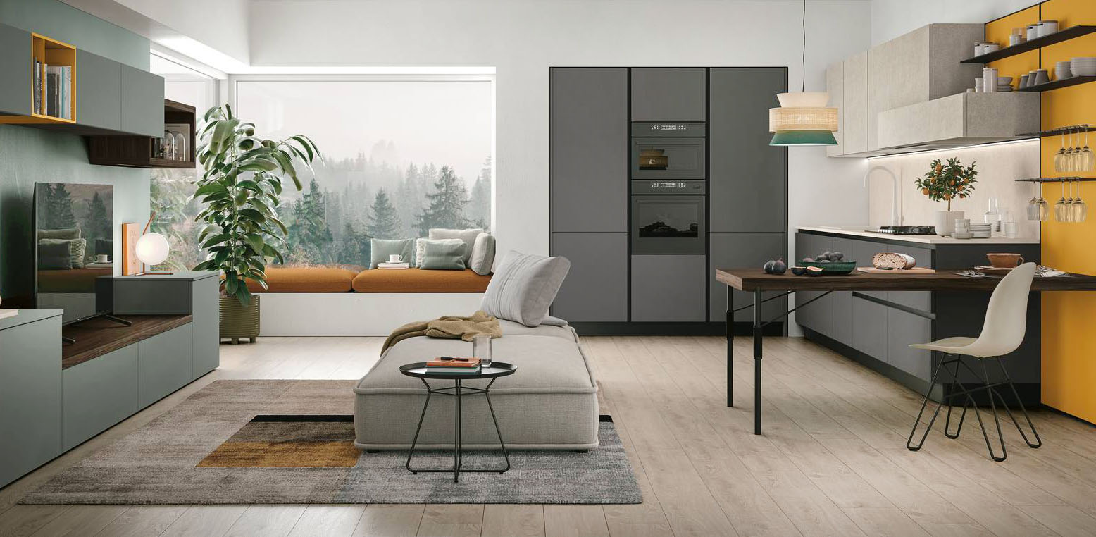 Allegra e colorata la zona giorno in cui trova posto la cucina Young di Stosa che ha le basi e le colonne in laminato Basalto e la boiserie attrezzata Linea in laccato opaco Topazio con un pratico piano snack in termo strutturato Rovere Cumino. La parete del living è arredata con una serie di moduli coordinati in laminato Giada. Prezzo su richiesta. https://www.stosacucine.com