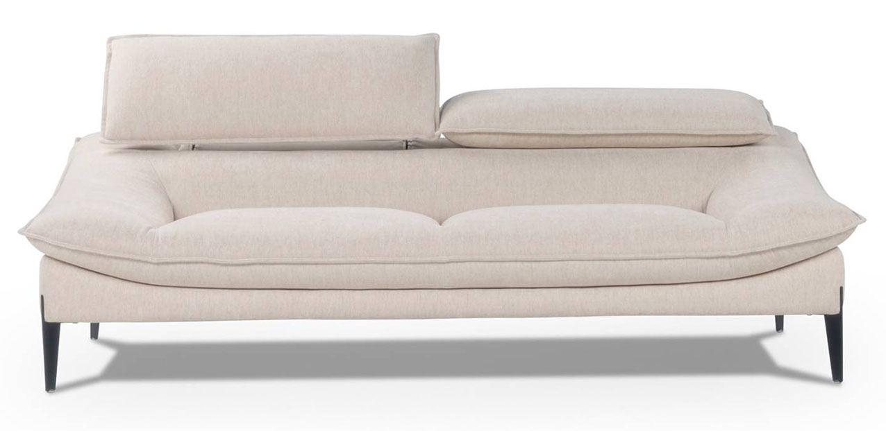 Il divano Flan di Calia Italia è elegante e leggero: i sottili piedini in metallo nero sollevano la struttura con la cuscinatura a saponetta che crea una continuità visiva tra il bracciolo inclinato  e la seduta. Il rivestimento in tessuto è valorizzato da una cucitura a pizzico. https://www.caliaitalia.com  -  Salone del mobile 2026, padiglione 01, Stand A06, B05.