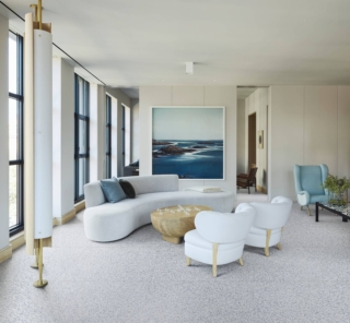 Salotto con divano bianco curvo e pavimento gres Marazzi Frammento