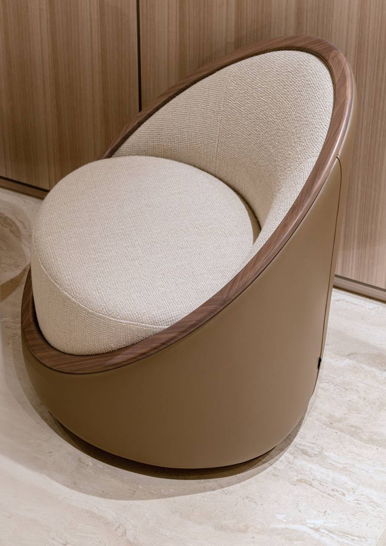 La poltroncina Artis Wood di Turri è composta da una seduta circolare, da uno schienale a mezzaluna e da una base cilindrica. È dotata di un meccanismo girevole che ne aumenta la versatilità e di un anello perimetrale in massello di noce, progettato per enfatizzare il contrasto dei materiali e il comfort della seduta. Misura L 92 x P 73 x H 77 cm. Prezzo a partire da 1.444€ + IVA. https://turri.it